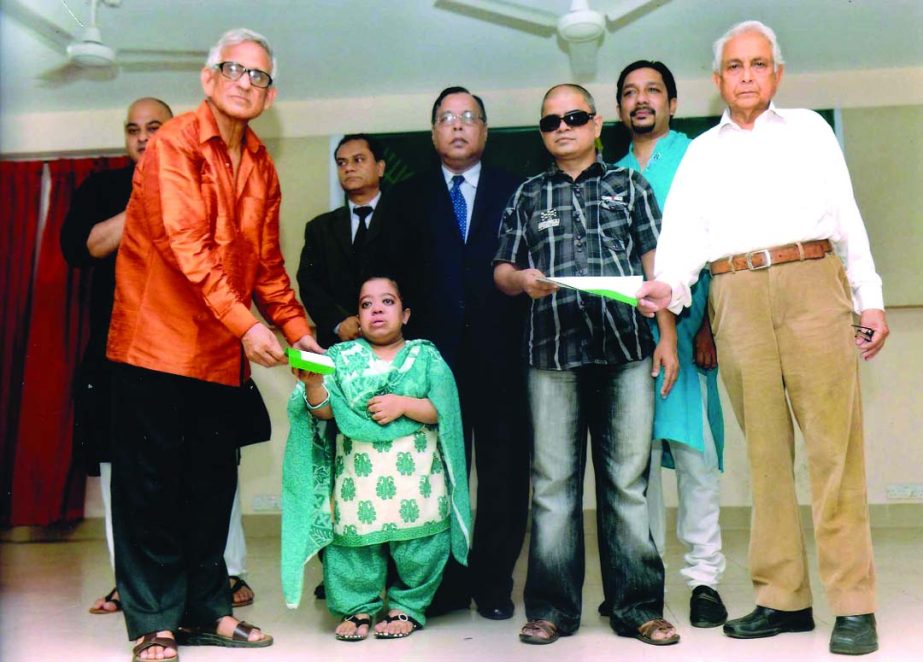 Hafiz Ahmed Mazumder, Chairman of the Board of Directors of Pubali Bank handing over appointment letters to physically disabled Sanjida Rahman and visually disabled Dewan Salamat Raza Chowdhury in Sylhet recently. Pubali Bank have taken decision to appoin