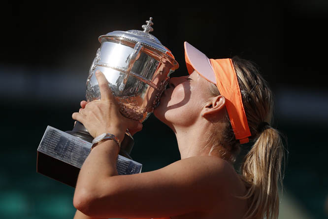 Russia's Maria Sharapova kisses the trophy after winning the final of the French Open tennis tournament against Romania's Simona Halep at the Roland Garros stadium in Paris, France on Saturday. Sharapova won in three sets 6-4, 6-7, 6-4.