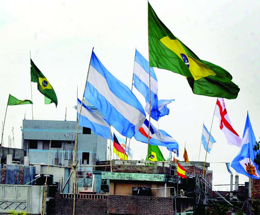 Mad rush of hoisting flags of World Cup Football teams particularly of Brazil and Argentina on rooftops now a common phenomena in the city. This photo was taken from outskirts of the city Amin Bazar area on Sunday.