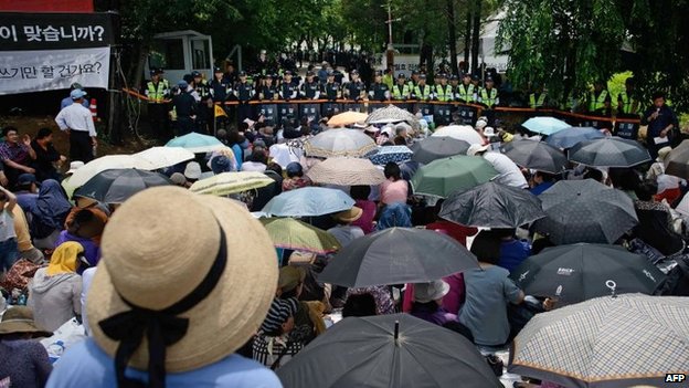 Supporters of Mr Yoo's Church faced off with police outside the compound