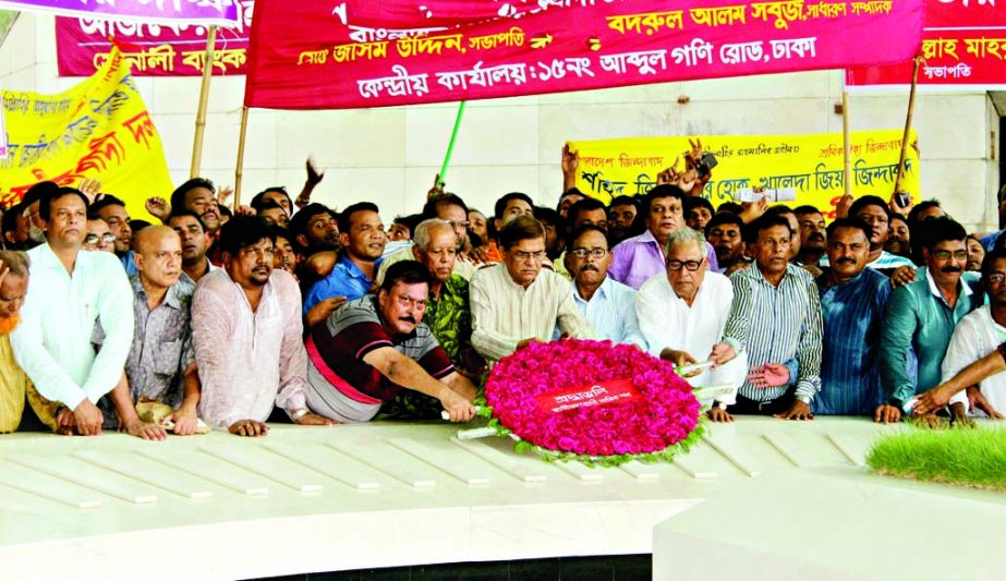 Leaders and activists of the newly formed Jatiyatabadi Sramik Dal led by BNP Acting Secretary General Mirza Fakhrul Islam Alamgir placing floral wreaths at the Mazar of Shaheed President Ziaur Rahman in the city on Wednesday.