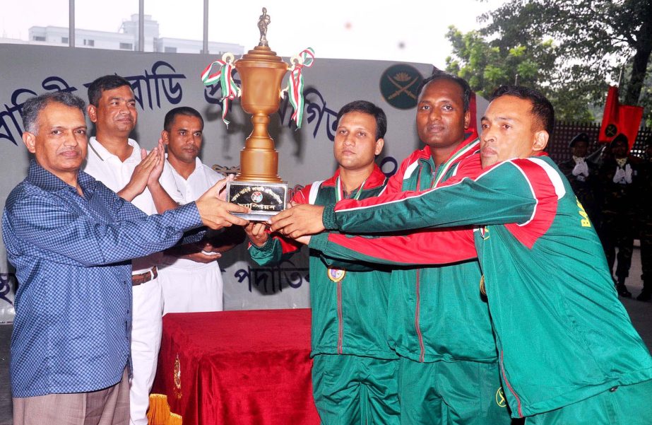 Assistant Chief of Bangladesh Navy Rear Admiral Riazuddin Ahmed handing over the trophy to Bangladesh Army Kabaddi team, which emerged champions of the Inter-Service Kabaddi Competition at the Dhaka Cantonment on Wednesday.