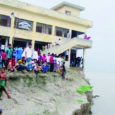 BOGRA : The erosion of the mighty river Jamuna has threatened Char Chluyabari Primary School at Sariyakandi Upazila. The picture was taken on Wednesday.