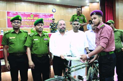 SAVAR: Dr Md Enamur Rahman MP of Dhaka-19 Constituency handing over a bi-cycle to a Union VDP leader at Upazila Ansar & VDP rally held at Savar Enam Medical Auditorium recently. Dhaka Range Director Mahboob- Ul -Islam was present as special guest. Sav