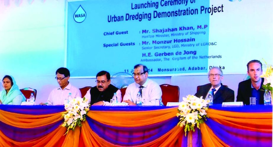 Shipping Minister Shajahan Khan inaugurating Dhaka WASA initiated "Clean the Canals and Box Culverts of Dhaka City" in association with Vitens Evides International of the Netherlands at Adabar in the city on Wednesday. Monzur Hossain, Sr Secretary of Lo