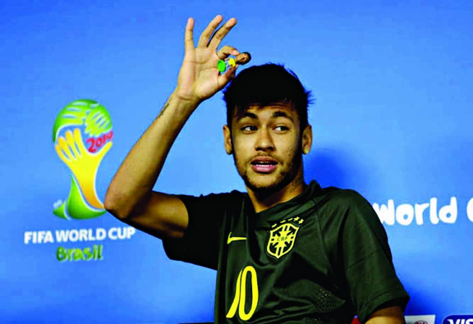 Brazil's Neymar shows bobble head of himself as he leaves from a press conference the day before the group A World Cup soccer match between Brazil and Croatia at the Itaquerao Stadium in Sao Paulo, Brazil on Wednesday.