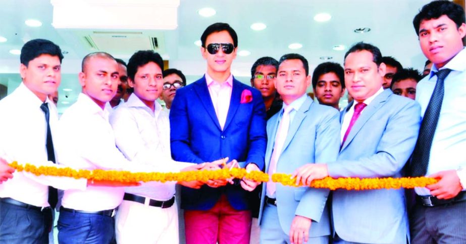 Model Nobel and Syed Hossain, Managing Director of Top Ten Fabrics and Tailors Ltd. inaugurating new outlet of the company at Mohammadpur in the city recently.