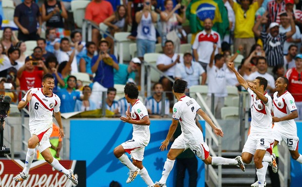 Costa Rica's players celebrate their second goal against Uruguay during their 2014 World Cup Group D soccer match at the Castelao stadium in Fortaleza, June 14, 2014. Credit: Reuters