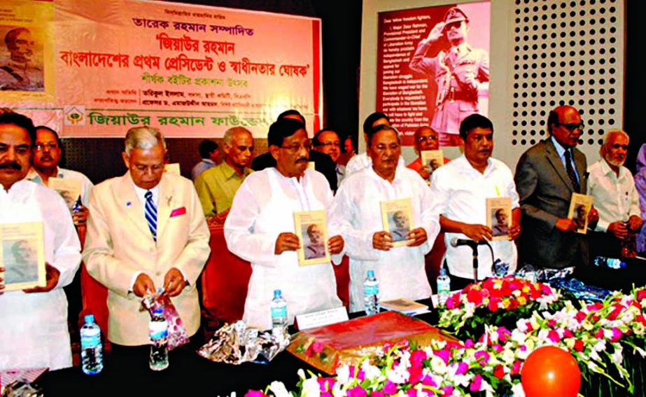 BNP Standing Committee member Tariqul Islam along with other distinguished guests holds the copies of a book titled 'Ziaur Rahman is the first President of Bangladesh and proclaimer of the Independence' edited by Tareque Rahman at its cover unwrapping c