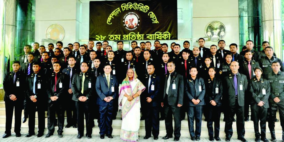 Prime Minister Sheikh Hasina along with Special Security Force (SSF) officials pose for photograph at the SSF Officers' Mess in the city on Sunday on the occasion of its 28th founding anniversary. BSS photo