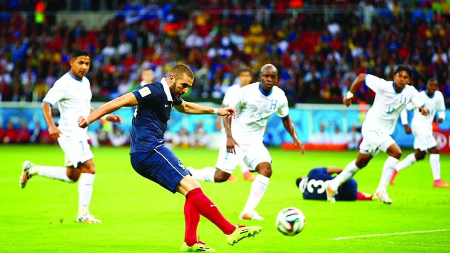 Karim Benzema of France shoots and scores his team's third goal, his second during the 2014 FIFA World Cup Brazil Group E match between France and Honduras at Estadio Beira-Rio in Porto Alegre, Brazil on Sunday.