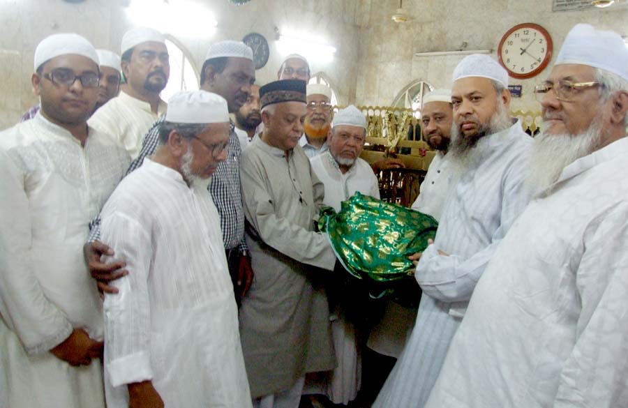 CCC Mayor M. Monzoor Alam presenting 'Gilap' to Hazrat Shah Sufi Amanat Khan (RA) Mazar in Chittagong yesterday.