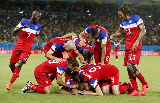 The United States team surrounds John Brooks after he scored his side's second goal to defeat Ghana 2-1 during the group G World Cup soccer match between Ghana and the United States at the Arena das Dunas in Natal, Brazil on Monday.