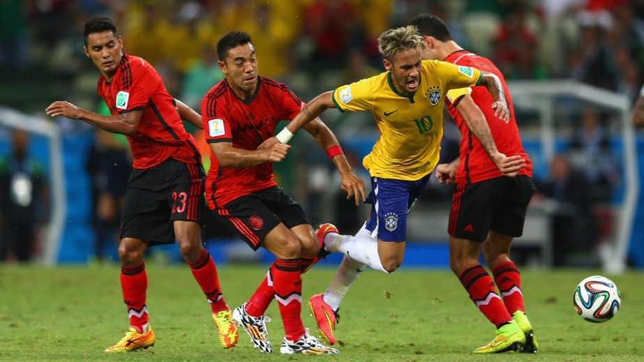 Neymar of Brazil is challenged by Jose Juan Vazquez of Mexico, Rafael Marquez and Marco Fabian during the 2014 FIFA World Cup Brazil Group A match between Brazil and Mexico at Castelao on Tuesday in Fortaleza, Brazil.