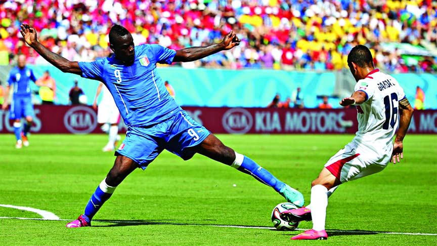 Mario Balotelli of Italy and Cristian Gamboa of Costa Rica compete for the ball during the 2014 FIFA World Cup Brazil Group D match between Italy and Costa Rica at Arena Pernambuco in Recife, Brazil on Friday. Costa Rica lead the match 1-0 in first half.