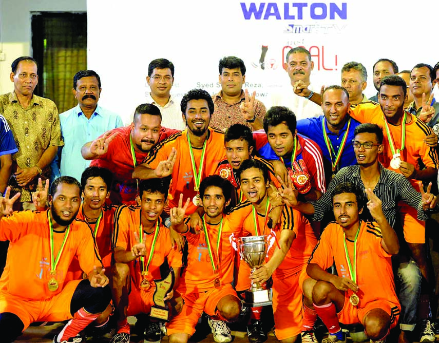 IUBAT, the champions of the Walton Smart TV Just Goal Football Tournament with the chief guest Additional Director of RB Group FM Iqbal Bin Anwar Don pose for a photo session at the Shaheed (Captain) M Mansoor Ali National Handball Stadium on Sunday.