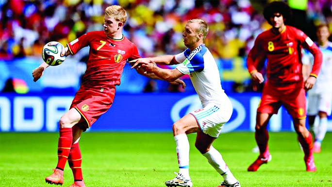 Kevin De Bruyne of Belgium controls the ball against Denis Glushakov of Russia during the 2014 FIFA World Cup Brazil Group H match between Belgium and Russia at Maracana in Rio de Janeiro, Brazil on Sunday night.