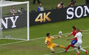 Algeria's Islam Slimani (R) scores the first goal as South Korea's goalkeeper Jung Sung-ryong (L) fails to stop the ball during their 2014 World Cup Group H soccer match at the Beira Rio stadium in Porto Alegre, June 22, 2014. Credit: Reuters