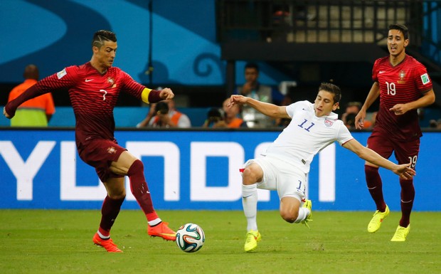 Portugal's Cristiano Ronaldo fights for the ball with Alejandro Bedoya of the US during their 2014 World Cup G soccer match at the Amazonia arena in Manaus,