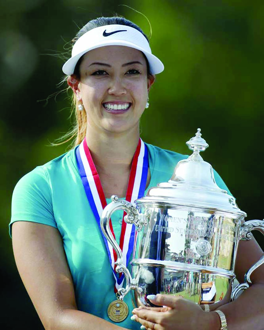 Michelle Wie holds the trophy after winning the US Women's Open golf tournament in Pinehurst NC on Sunday.