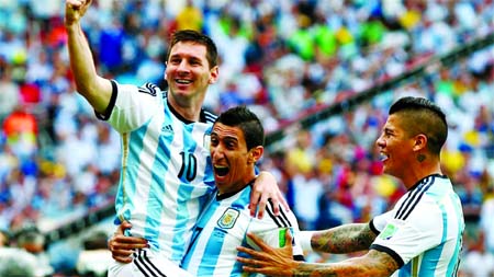 Lionel Messi (L) of Argentina celebrates scoring his team's first goal with his teammates Angel di Maria (C) and Marcos Rojo (R) during the 2014 FIFA World Cup Brazil Group F match between Nigeria and Argentina at Estadio Beira-Rio in Porto Alegre, Brazi