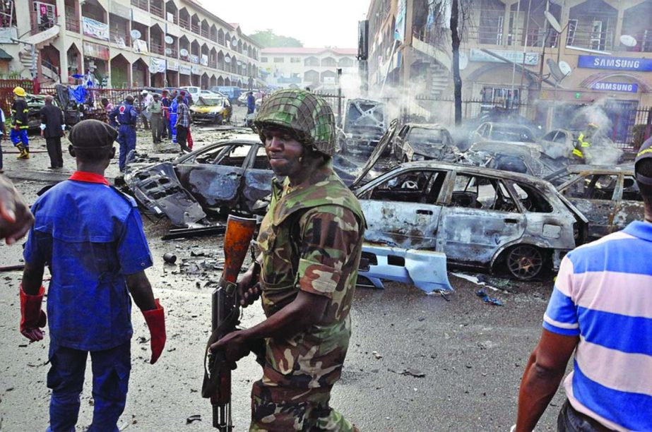 A Nigerian soldier at the scene of the explosion in the capital Abuja.