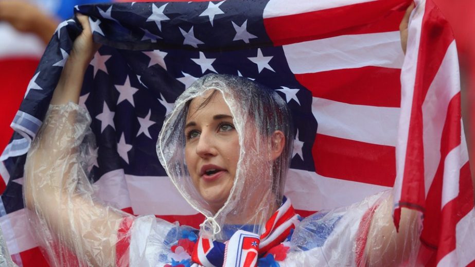 A USA fan looks on in the rain prior to the 2014 FIFA World Cup Brazil group G match between the USA and Germany at Arena Pernambuco in Recife, Brazil on Thursday .