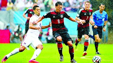 Clint Dempsey of the United States challenges Mesut Oezil of Germany during the 2014 FIFA World Cup Brazil group G match between the United States and Germany at Arena Pernambuco in Recife on Thursday.