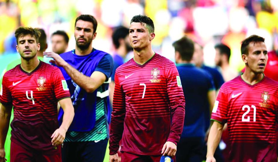 (L-R) Miguel Veloso, Cristiano Ronaldo and Joao Pereira of Portugal show their dejection after the 2014 FIFA World Cup Brazil Group G match between Portugal and Ghana at Estadio Nacional in Brasilia, Brazil on Thursday.