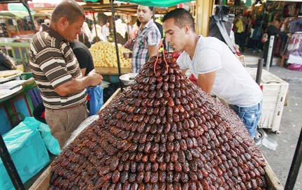 A Palestinian vendor sells dates for Ramzan at a market in the West Bank City of Jenin ahead of Ramzan. Muslims throughout the world are preparing themselves before the holy month of Ramzan, where observants fast from dawn till dusk.