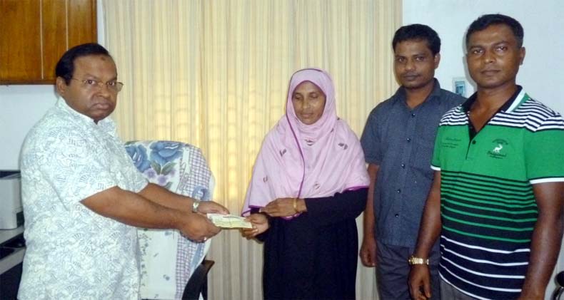 M A Khaleque Khan, Divisional Forest Officer of Wild Life Management and Nature Preservation giving cheque of Tk one lakh to wife of late Faridul Alam who was killed by wild elephant at Cox's Bazar recently.