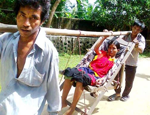 A sick woman is carrying in such a way as the ambulance of Baghaichhori Health Complex in Rangamati was inoperative for long time.