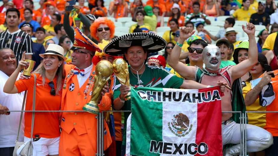 Mexico and Dutch fans soak up the atmosphere prior to the 2014 FIFA World Cup Brazil Round of 16 match between Netherlands and Mexico at Estadio Castelao in Fortaleza, Brazil on Sunday.
