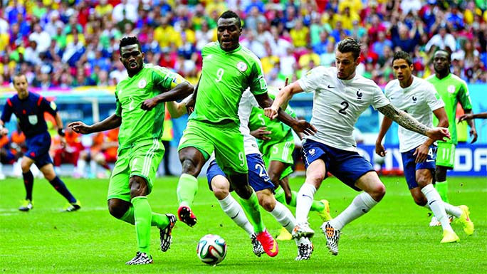 Emmanuel Emenike of Nigeria controls the ball against Mathieu Debuchy of France during the first half of FIFA World Cup Brazil Round of 16 match between France and Nigeria at Estadio Nacional in Brasilia, Brazil on Monday.