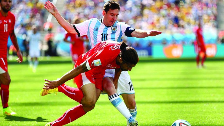 Ricardo Rodriguez of Switzerland challenges Lionel Messi of Argentina during the 2014 FIFA World Cup Brazil Round of 16 match between Argentina and Switzerland at Arena de Sao Paulo in Sao Paulo, Brazil on Tuesday.