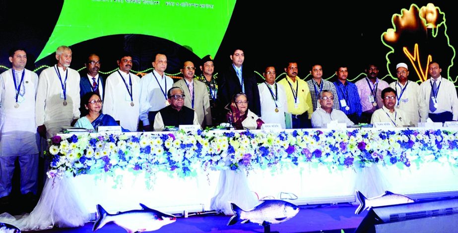 Prime Minister Sheikh Hasina along with the awards recipients for contribution in fisheries sector pose for photograph at the inauguration of National Fisheries Week at Bangabandhu International Conference Center in the city on Wednesday. BSS photo