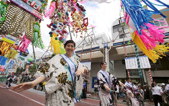 People dance under colorful decorations for the Tanabata Star Festival in Hiratsuka near Tokyo.