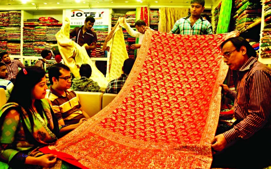 Shop owner demanding Tk 1,80,000 for a Bombay brand Stan Katan Saree at city's Gawsia Market on Friday.