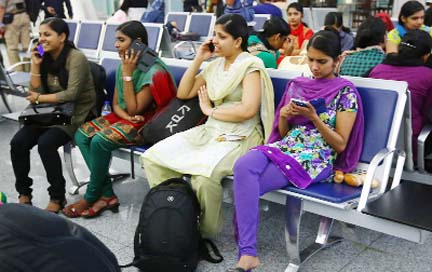 Indian nurses who were trapped in territory captured by Islamic militants wait for the plane to begin their journey home at Irbil International Airport, Iraq