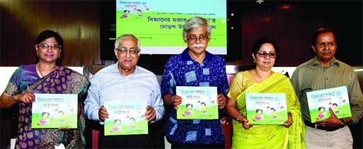 Former Adviser to the Caretaker Government Rasheda K Chowdhury along with other distinguished guests holds the copies of a book titled 'Bigganer Mojar Pathshala' at its cover unwrapping ceremony at Sheltech office in the city on Saturday.