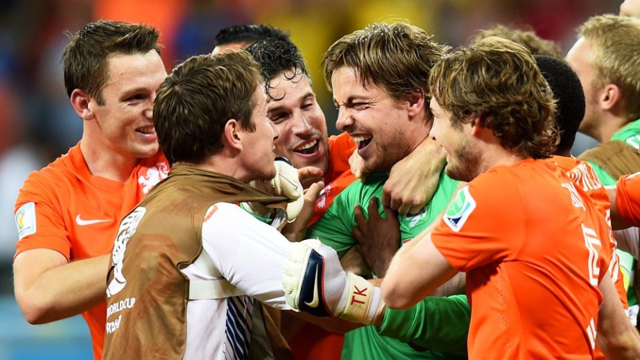 Goalkeeper Tim Krul of the Netherlands celebrates with teammates after making a save in a penalty shootout to defeat Costa Rica during the 2014 FIFA World Cup Brazil quarter final match between the Netherlands and Costa Rica at Arena Fonte Nova in Salvado