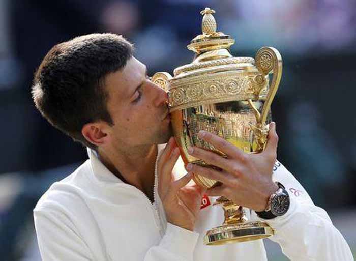 Novak Djokovic of Serbia kisses the winners trophy after defeating Roger Federer of Switzerland in their men's singles final tennis match at the Wimbledon Tennis Championships in London on Sunday.