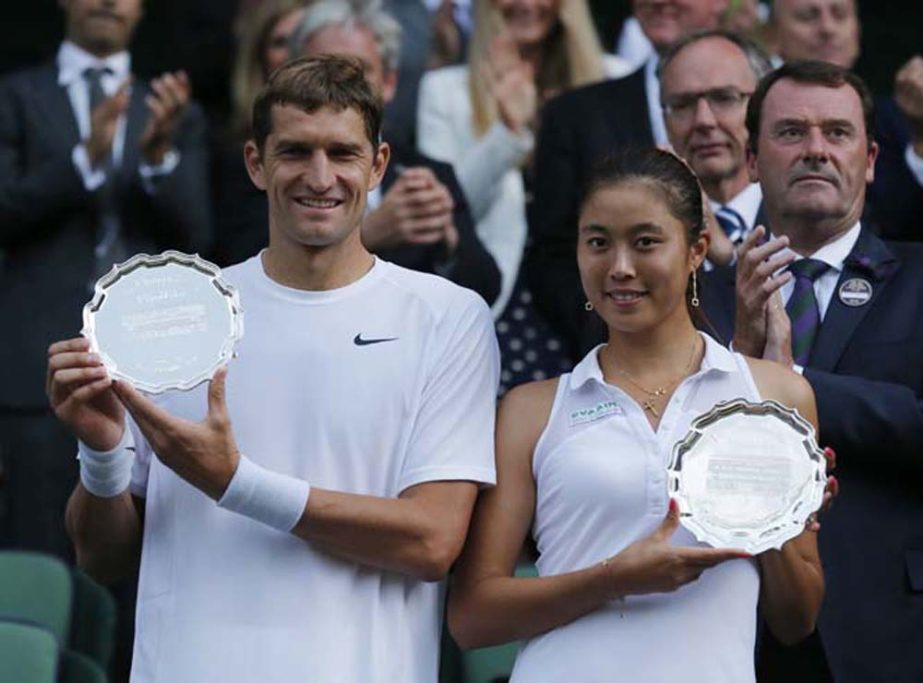 Max Mirnyi of Belarus and Hao-Ching Chan of Taiwan hold their runners up trophies after being defeated by Nenad Zimonjic of Serbia and Samantha Stosur of Australia in the mixed doubles final at the All England Lawn Tennis Championships in Wimbledon, Londo