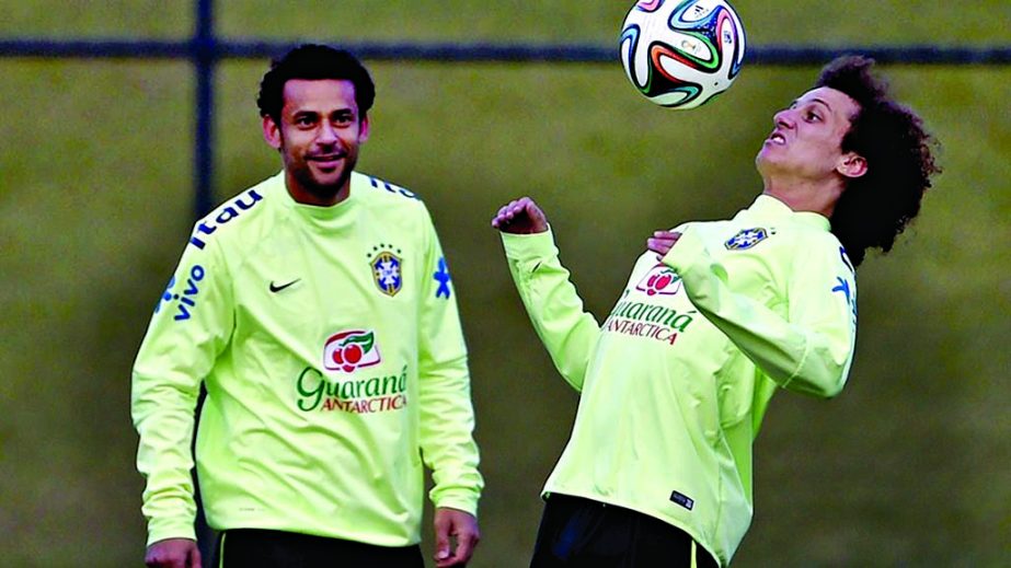 UNDAUNTED BRAZIL : David Luiz (R) controls the ball as Fred looks on during a training session at Granja Comary in Teresopolis, Brazil on Monday.