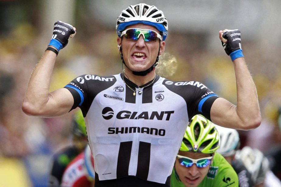 Germany's sprinter Marcel Kittel crosses the finish line ahead of celebrates on the podiums (bottom right) to win the third stage of the Tour de France cycling race over 155 kilometers (96.3 miles) with start in Cambridge and finish in London, England on