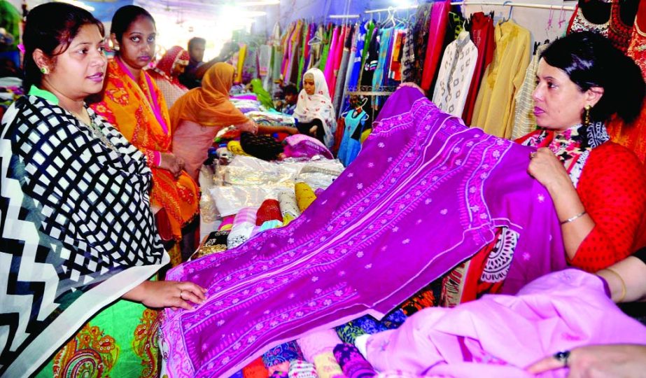 Customers making their choices at a Eid Fashion Fair organised by Nine-Eleven Collection in city's Baily Road on Wednesday.