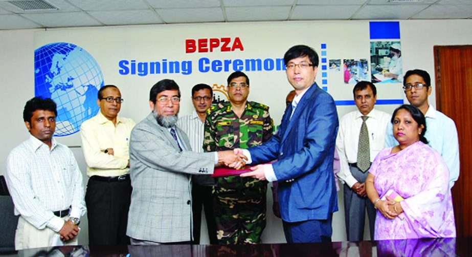 Sayed Nurul Islam, Member (Investment Promotion) of BEPZA and Kim Beom Joon, Managing Director of Campha Outdoor Ltd sign an agreement at BEPZA complex on Thursday to set up camping items plant at Karnaphuli EPZ.