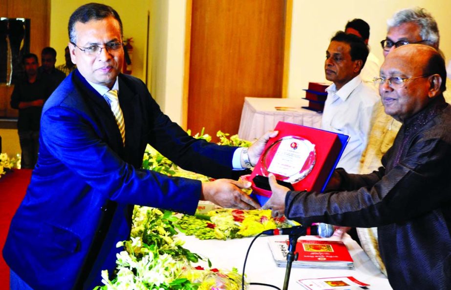 Commerce Minister Tofail Ahmed handing over highest VAT payer's award in service sector to Choudhury Atiur Rasul, Director (Accounts) of PRAN-RFL Group at a city convention centre on Thursday.