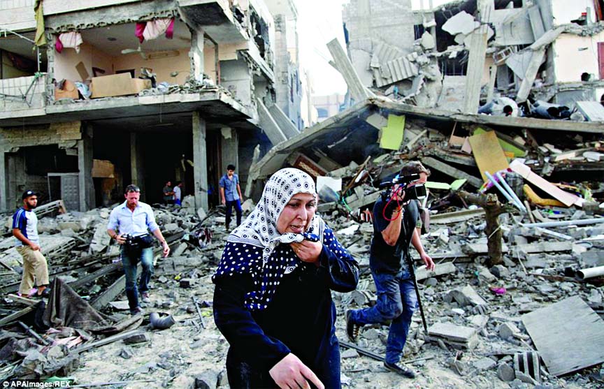MASS destruction: Palestinians inspect the remains of a Gaza City neighbourhood after an Israeli airstrike on Thursday morning.