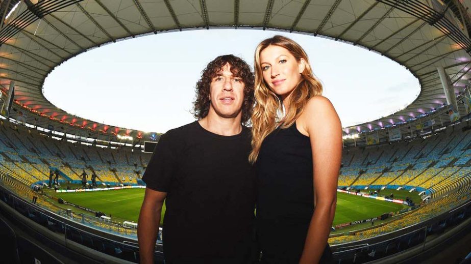 Retired Spanish International Carles Puyol and Brazilian supermodel Gisele Bundchen pose for a photo ahead of their unveiling of the FIFA World Cup trophy prior to the 2014 FIFA World Cup Final between Germany and Argentina at Maracana in Rio de Janeiro,